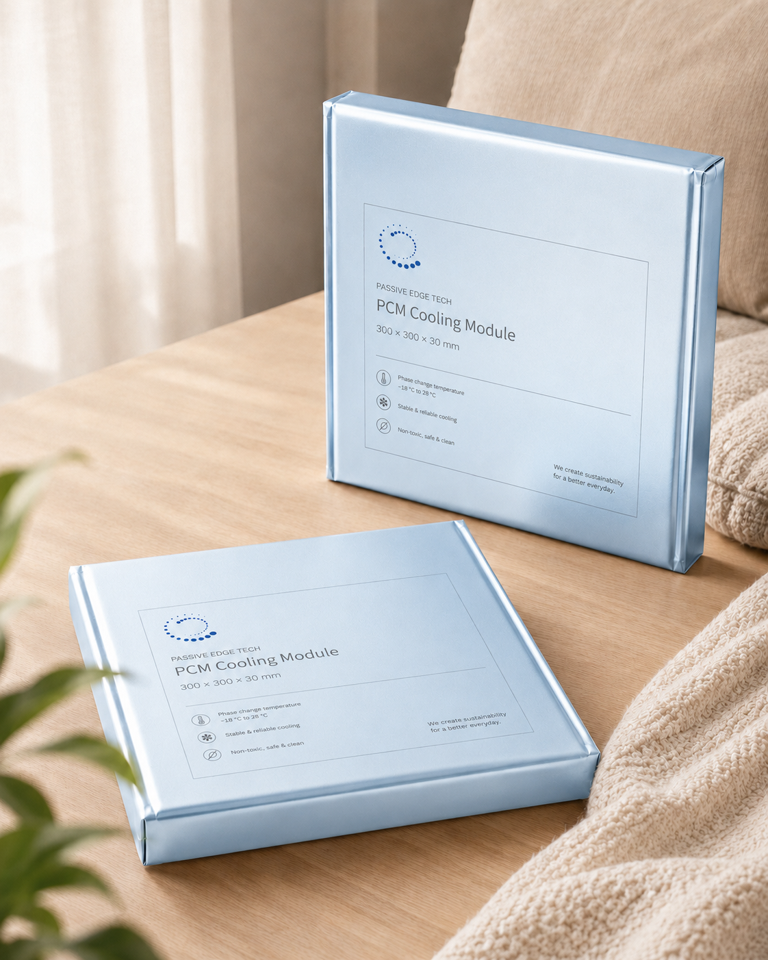 Two Passive Edge PCM Cooling Module packages, 300 by 300 by 30 millimetres, on a wooden table
