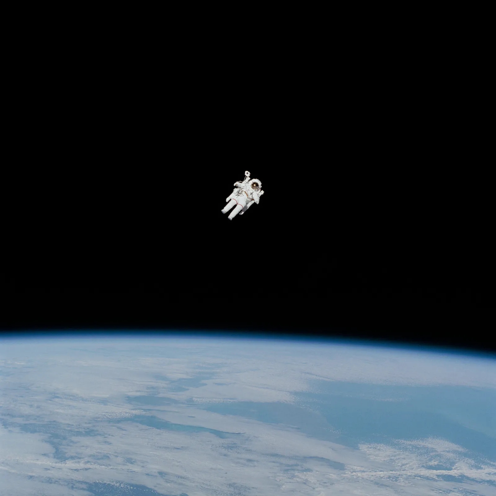 Astronaut floating above Earth, showing the space heritage of phase-change thermal comfort