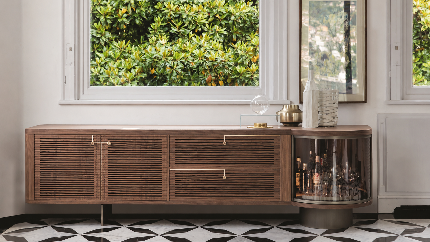 Walnut slatted sideboard by a window — the kind of furniture a PCM module bank retrofits into